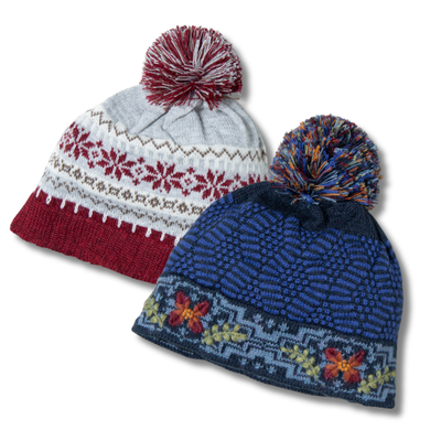 Two knitted hats with pom-poms on a white background