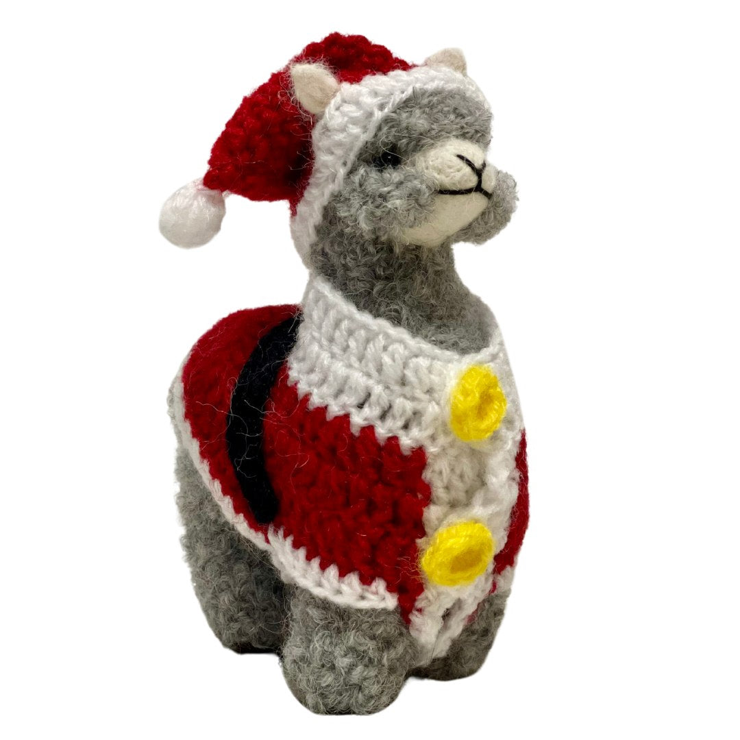 A product photo of a cute soft fluffy handmade toy light gray alpaca with a red and white santa hat a red and white santa suit with yellow buttons and a black belt felted woven alpaca wool figurine and ornament for christmas holiday gifts