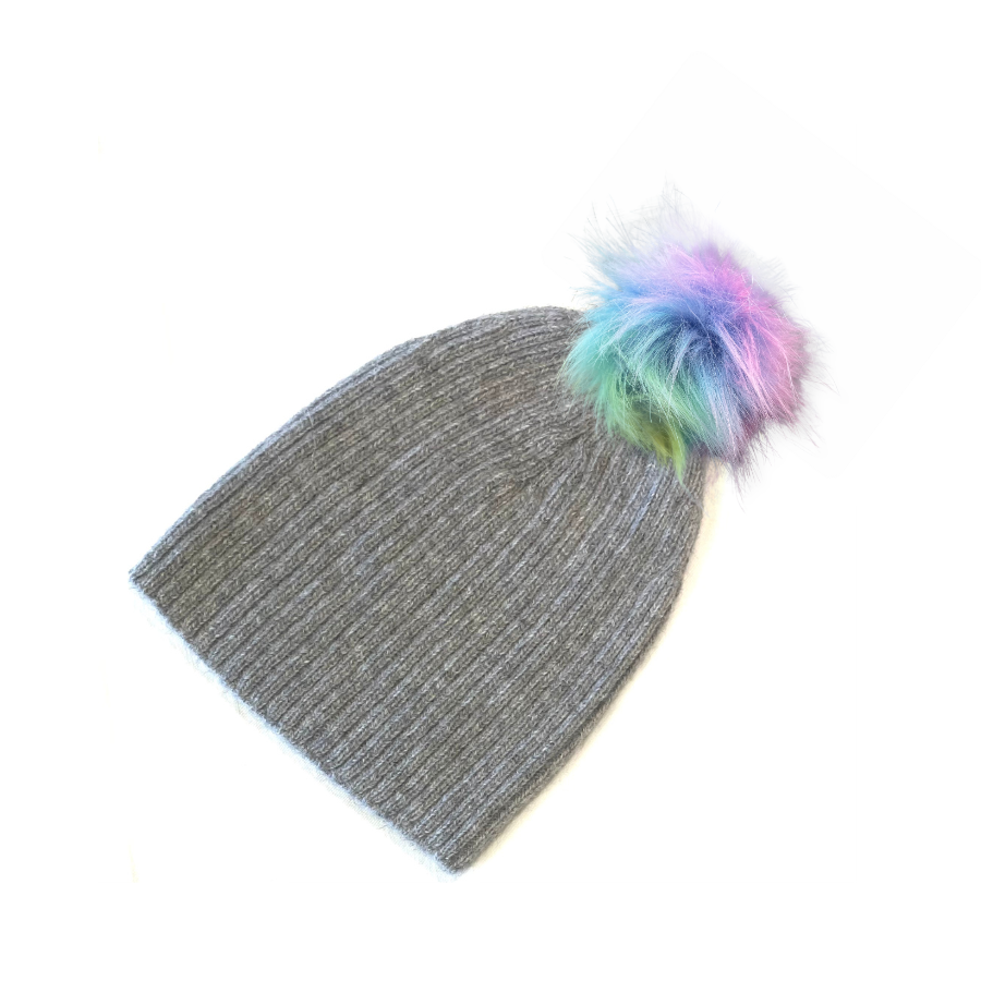A product photo of a soft warm winter cozy moisture wicking comfortable fashionable light gray alpaca wool beartooth beanie with a pastel rainbow blue green purple pink pom pom.