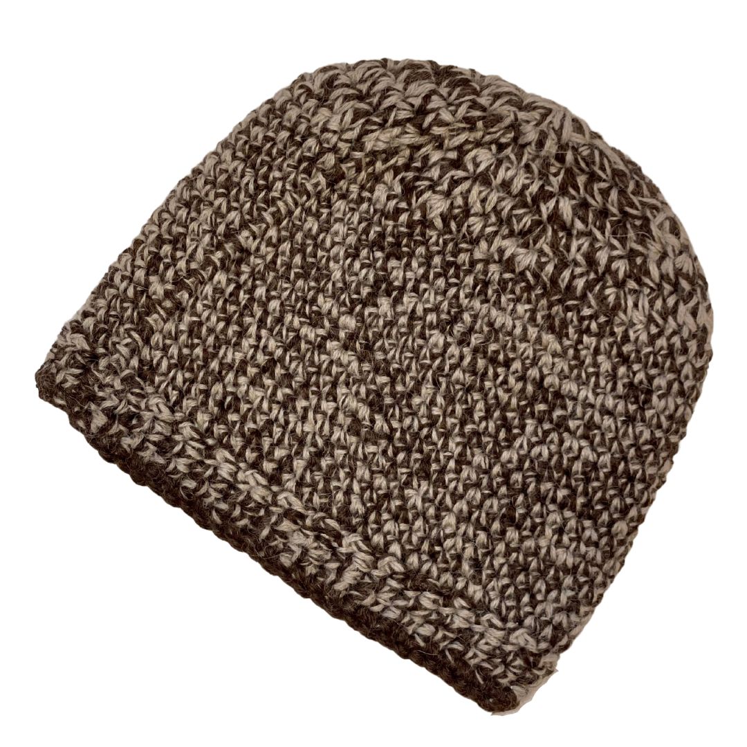 A product photo with a white background of an Alpacas of Montana soft cozy comfortable stylish thermal fashionable moisture wicking antimicrobial knitted crochet mountaineer skullcap beanie hat handmade in Montana from latte brown and cocoa chocolate brown alpaca wool and bamboo yarn.