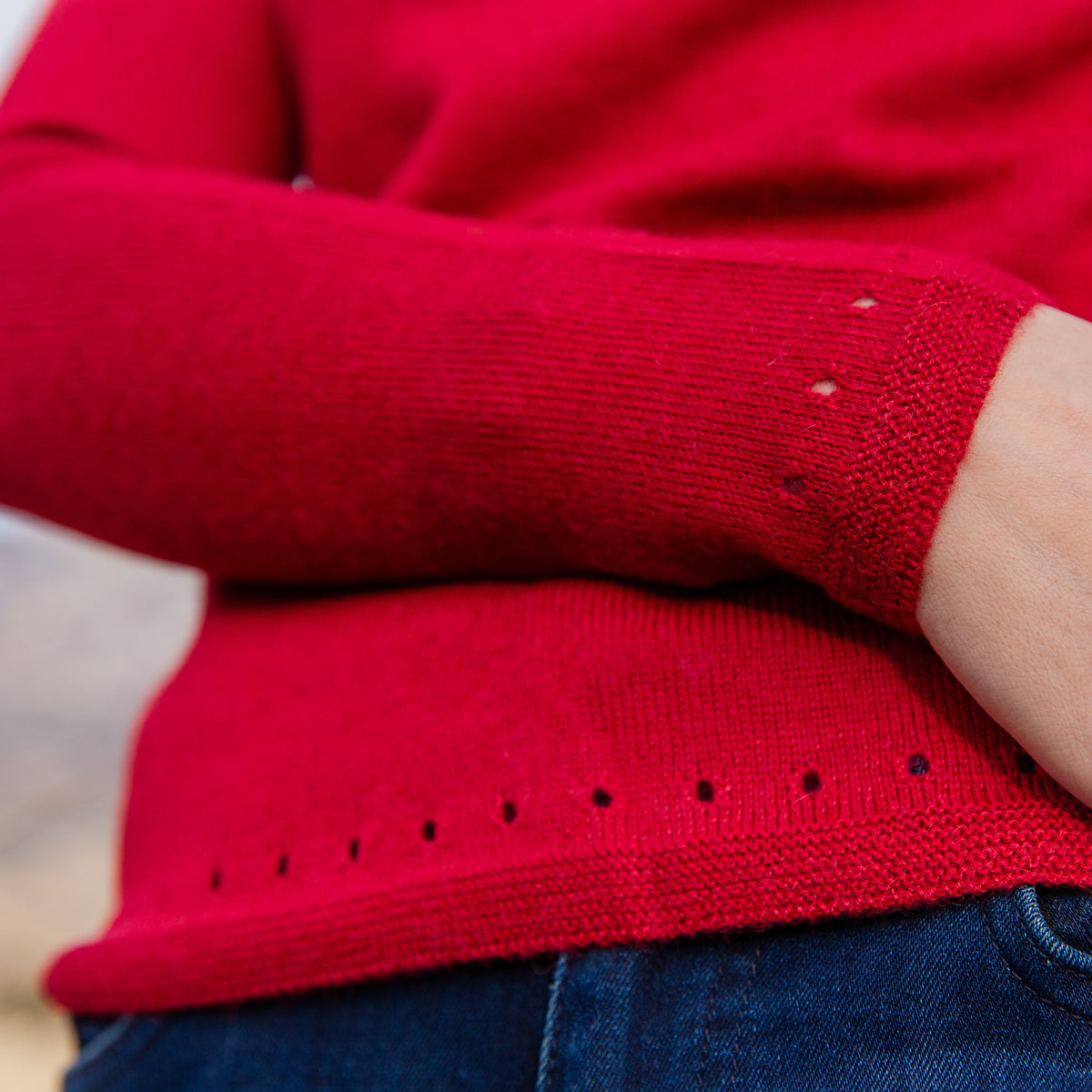 A close up photograph of the soft cozy comfortable pretty elegant fashionable scarlet red Luxe Light sweater for women.