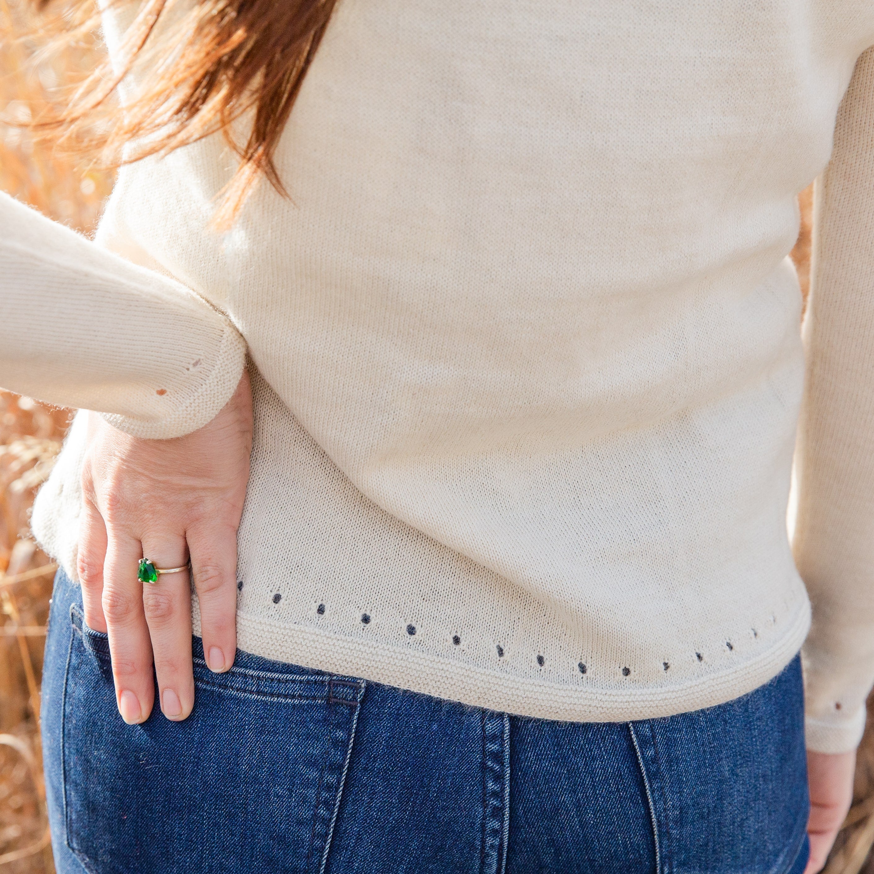 A close up photograph of the beautiful elegant soft cozy comfortable natural white Luxe Light sweater for women's fashion.