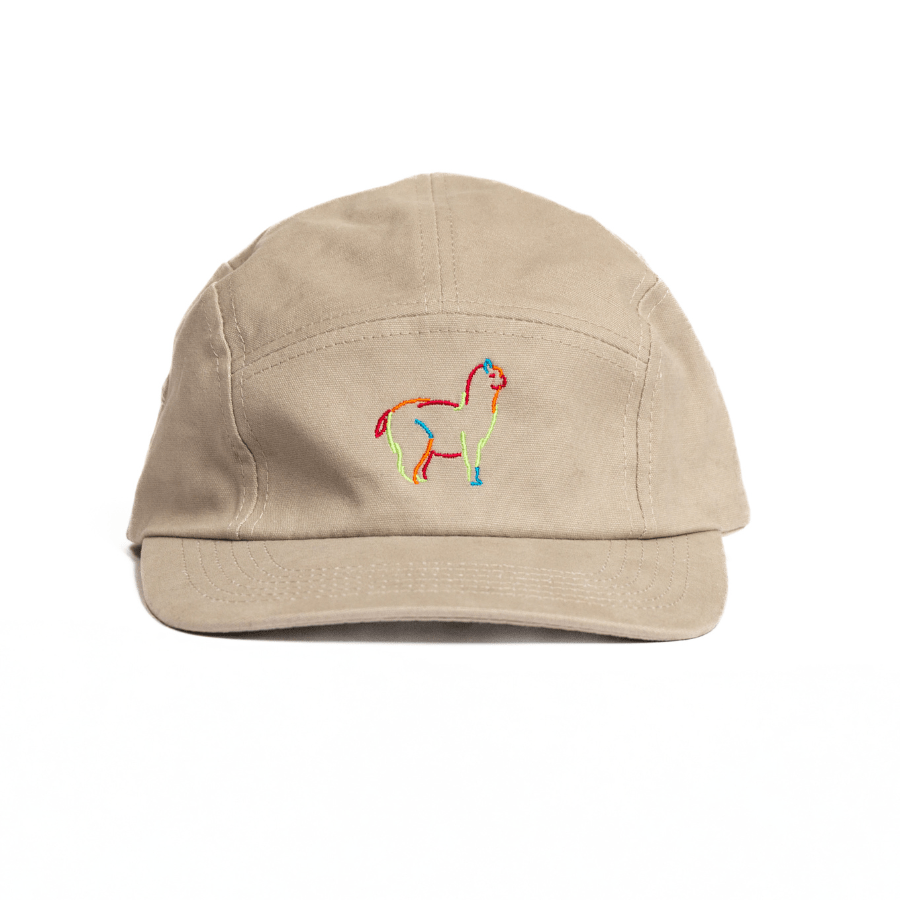 A beige Nike baseball cap with a colorful alpaca logo embroidery on the front.