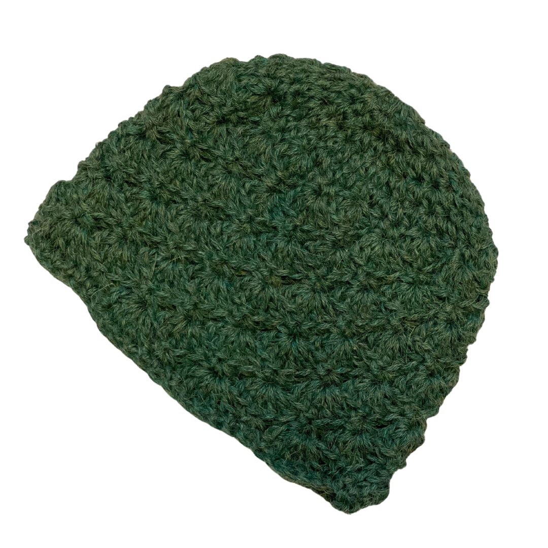 A product photo with a white background of a soft stylish cozy comfortable fashionable moisture wicking knitted crochet scallop pattern hat handmade in Montana from mossy natural green alpaca wool.