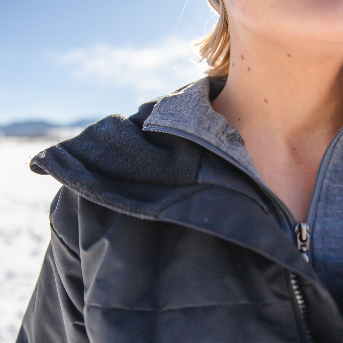 A close up photo of the collar of an Alpacas of Montana warm top layer insulated cozy comfortable thermal winter outerwear heavyweight alpaca wool lined graphite gray black granite peak expedition parka for skiing, snowboarding, ice fishing, hunting, camping, arctic, travel, outdoors