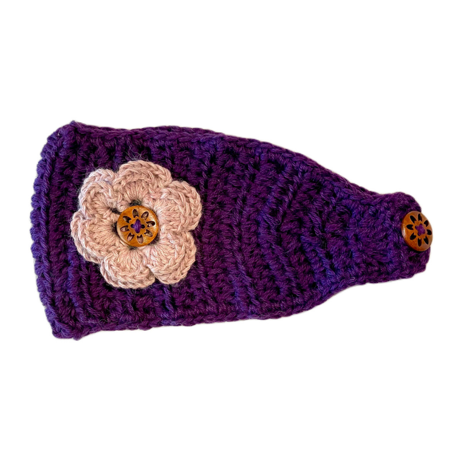 A product photo against a white background of a soft cute stylish fashion cozy comfortable warm winter headband and flower accessory handmade knit crochet in Montana from bright purple violet and light pink alpaca yarn