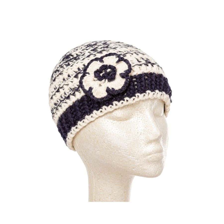 black and white hand knit alpaca beanie hat with flower on mannequin hat