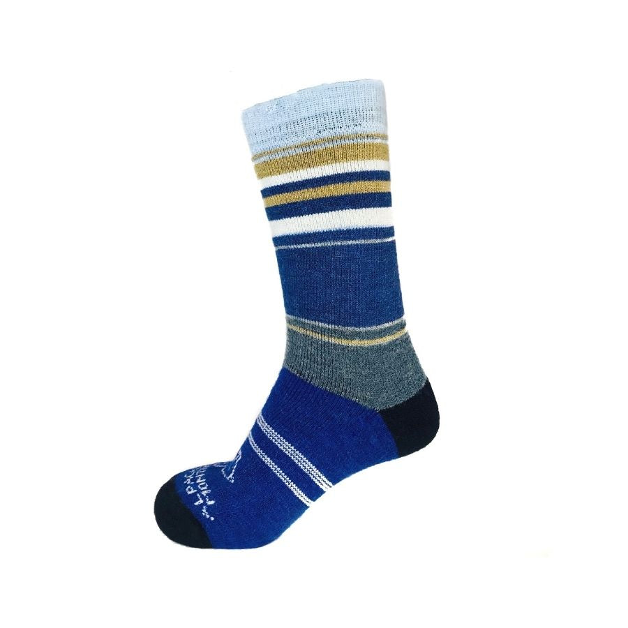 A product photo in front of a white background of a pair of the soft cozy comfortable moisture wicking lounge and active everyday bright blue, navy, cobalt, black, sky blue, gold, and natural white striped basecamp socks.