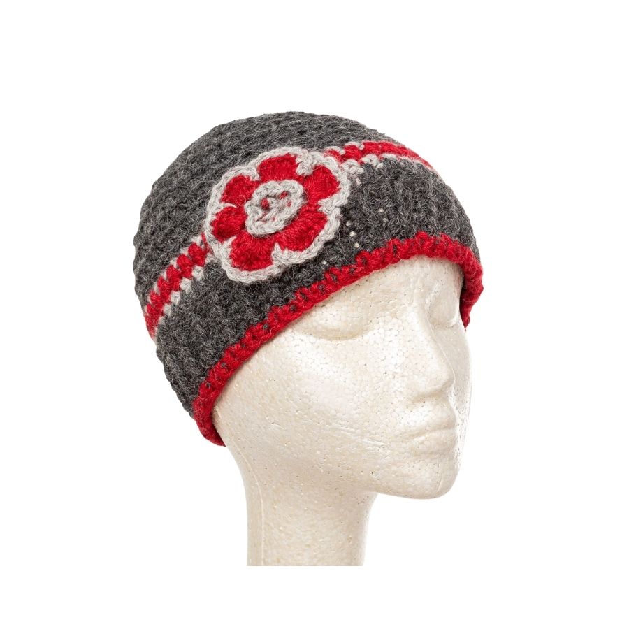 dark gray and red hand knit alpaca beanie hat with flower on mannequin head