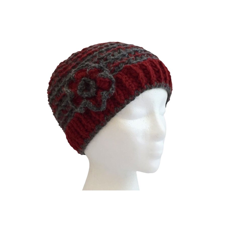 red and gray hand knit alpaca beanie hat with flower on mannequin head