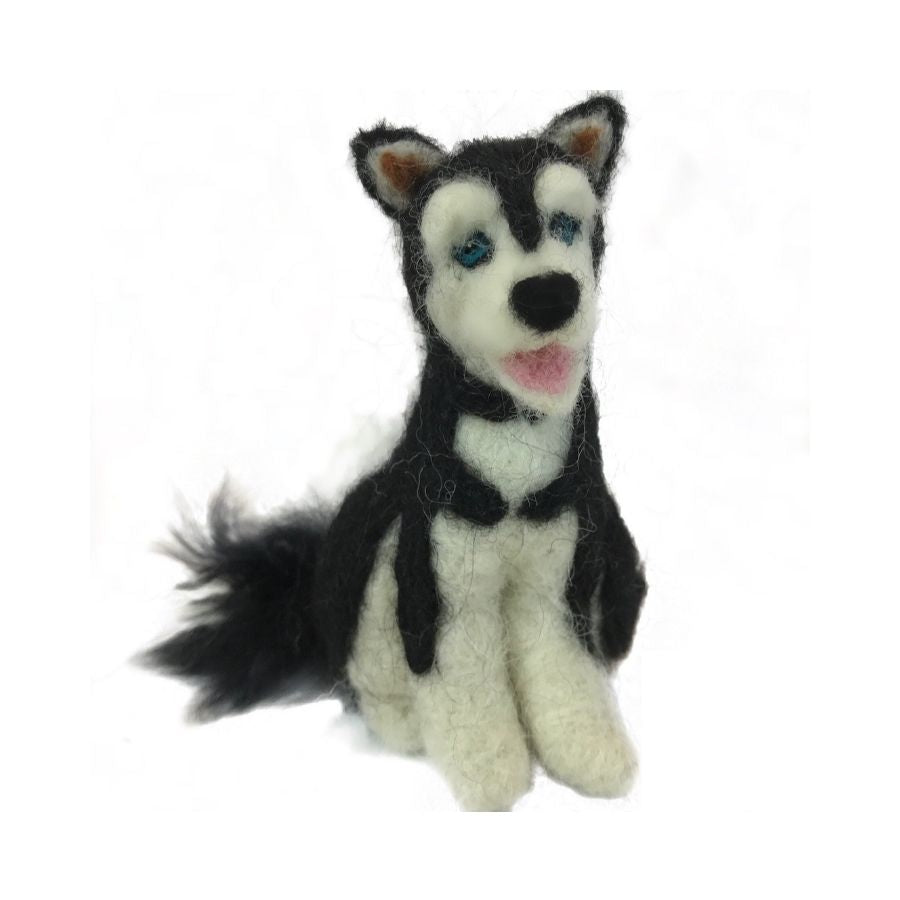 A product photo against a white background of a soft cute adorable gift toy birthday christmas black and natural white with blue eyes and pink tongue fluffy husky dog felted alpaca wool figurine and ornament.