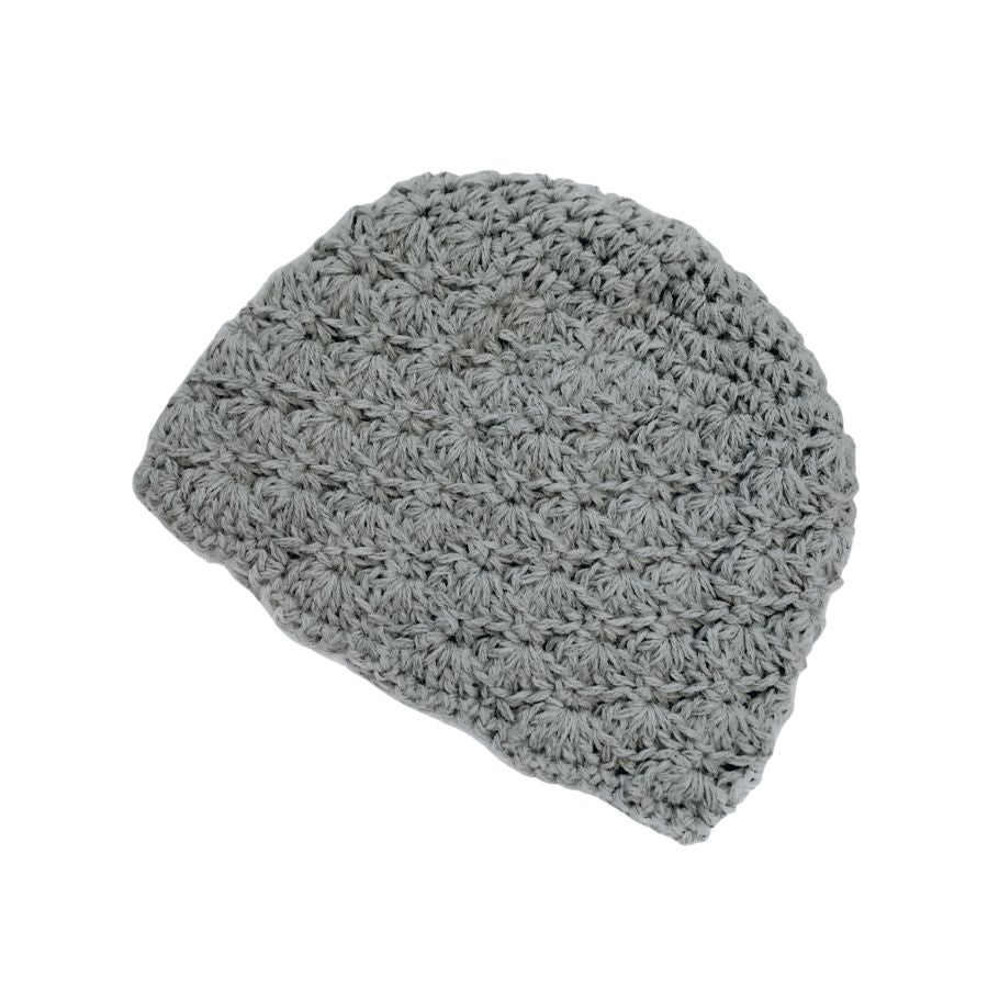 A product photo with a white background of a soft stylish cozy comfortable fashionable moisture wicking knitted crochet scallop pattern hat handmade in Montana from light gray alpaca wool.