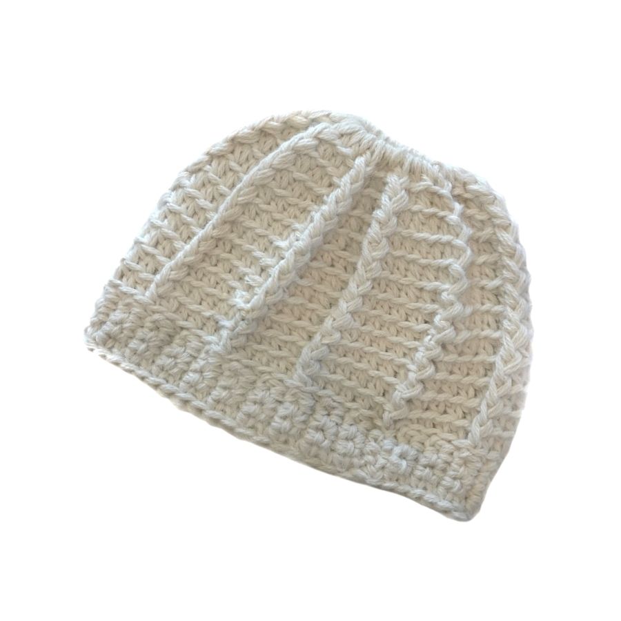 A product photo on a white background of a soft cozy comfortable fashionable moisture wicking knitted crochet ponytail hat handmade in Montana from natural white alpaca wool and bamboo yarn.