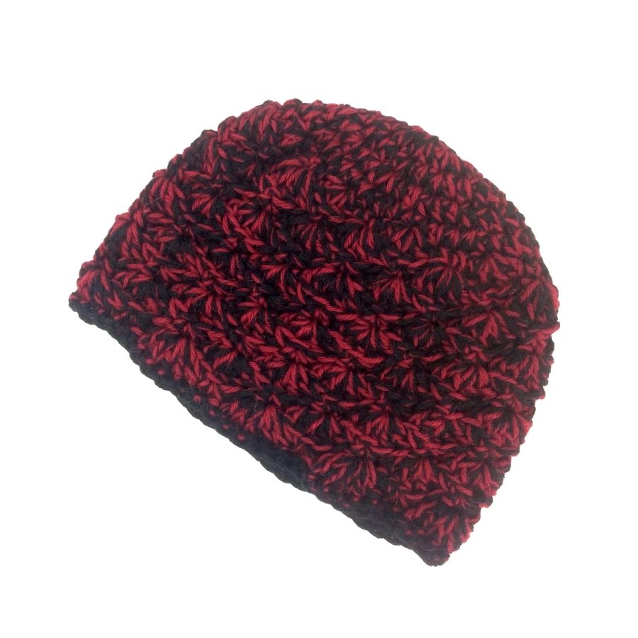 A product photo with a white background of a soft stylish cozy comfortable fashionable moisture wicking knitted crochet scallop pattern hat handmade in Montana from scarlet red and black alpaca wool.