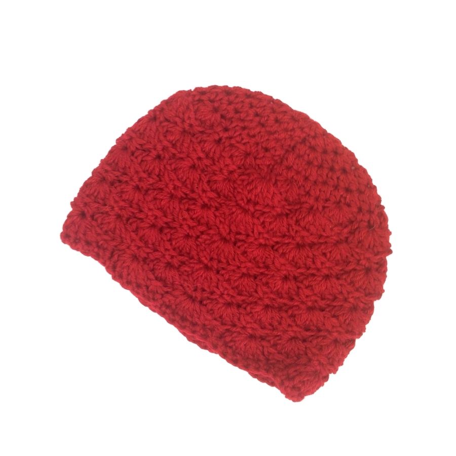 A product photo with a white background of a soft stylish cozy comfortable fashionable moisture wicking knitted crochet scallop pattern hat handmade in Montana from scarlet red alpaca wool.