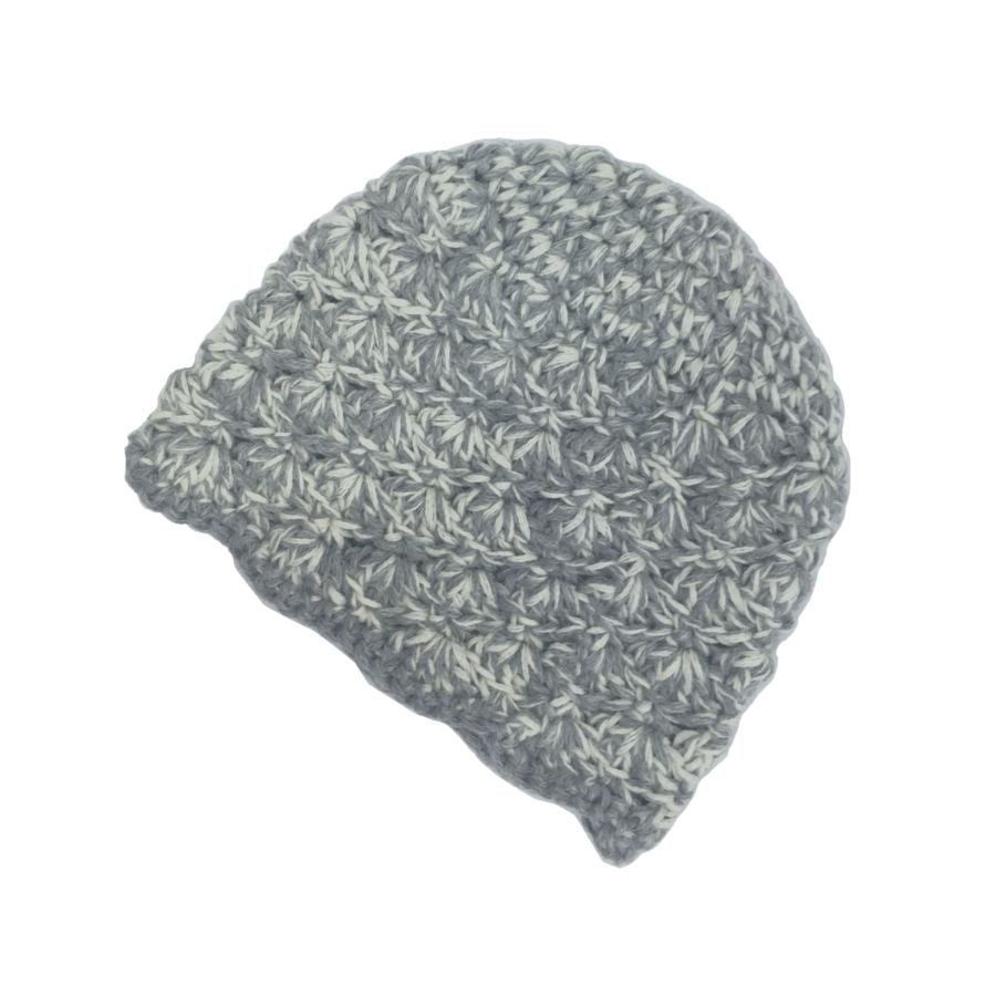 A product photo with a white background of a soft stylish cozy comfortable fashionable moisture wicking knitted crochet scallop pattern hat handmade in Montana from natural white and light gray alpaca wool.