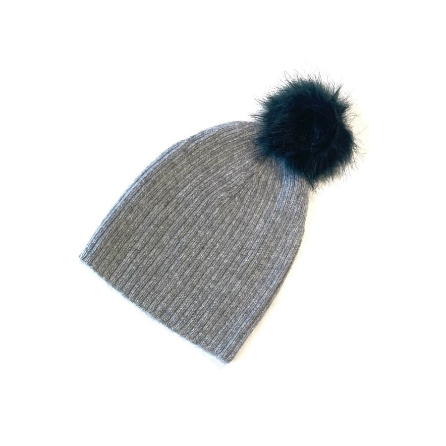 A product photo of a soft warm winter cozy moisture wicking comfortable fashionable light gray alpaca wool beartooth beanie with a dark forest green pom pom.