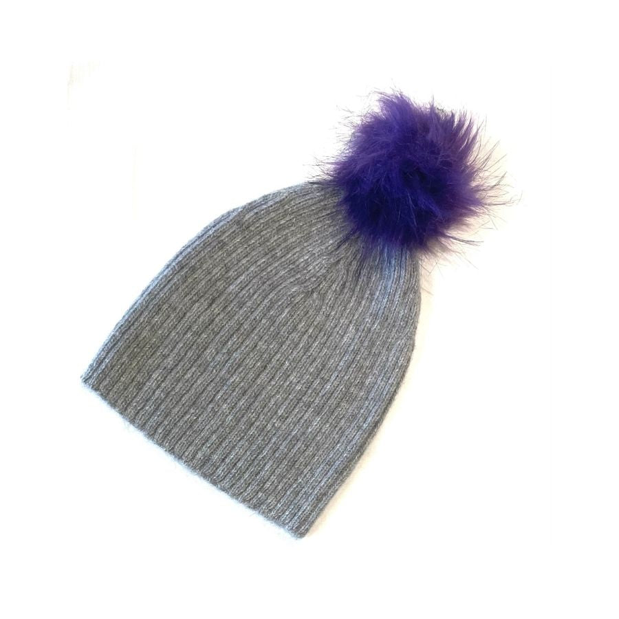 A product photo of a soft warm winter cozy moisture wicking comfortable fashionable light gray alpaca wool beartooth beanie with a purple violet pom pom.