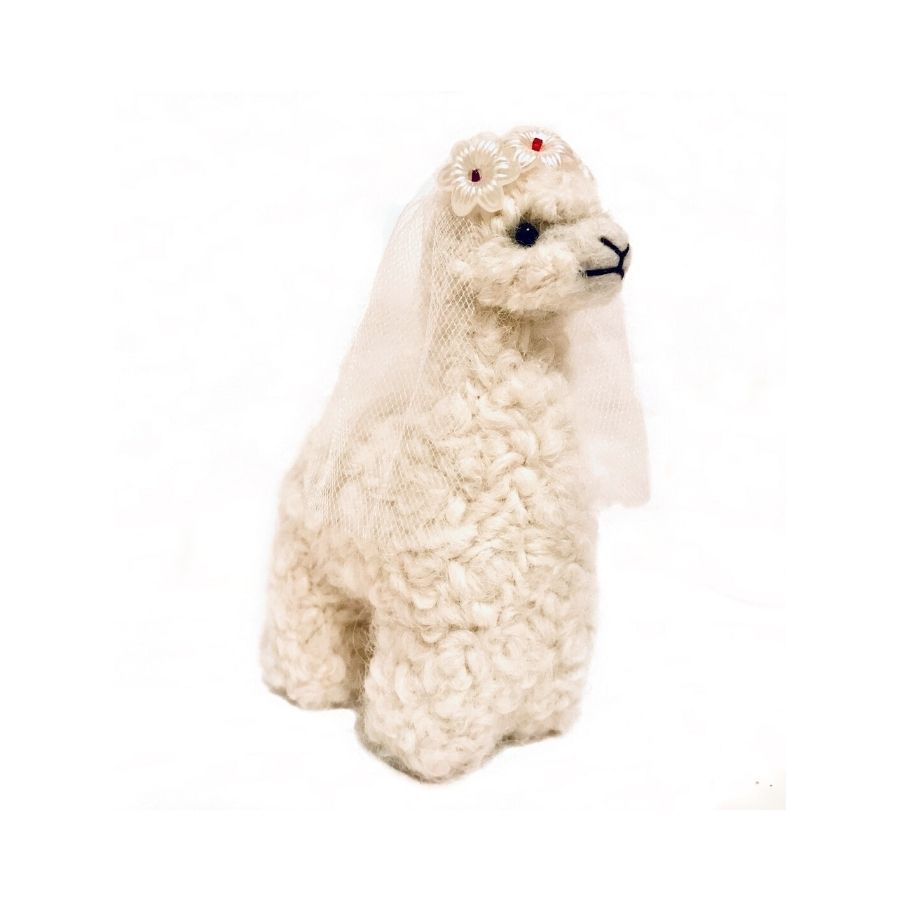 A white colored bride alpaca figurine and ornament wearing a white vail and white flowers