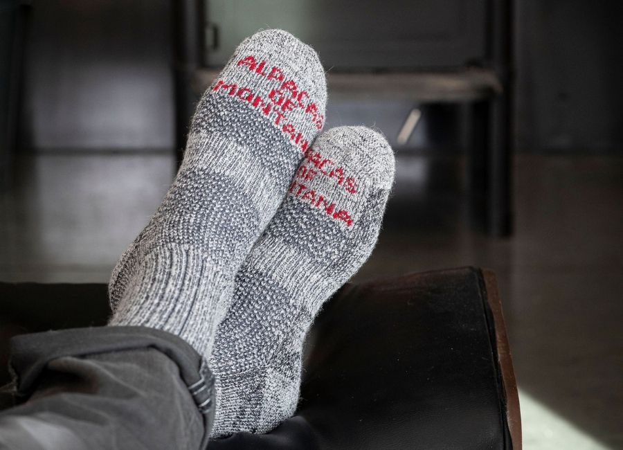 Person putting on boot sock