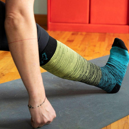 Person stretching wearing compression alpaca socks