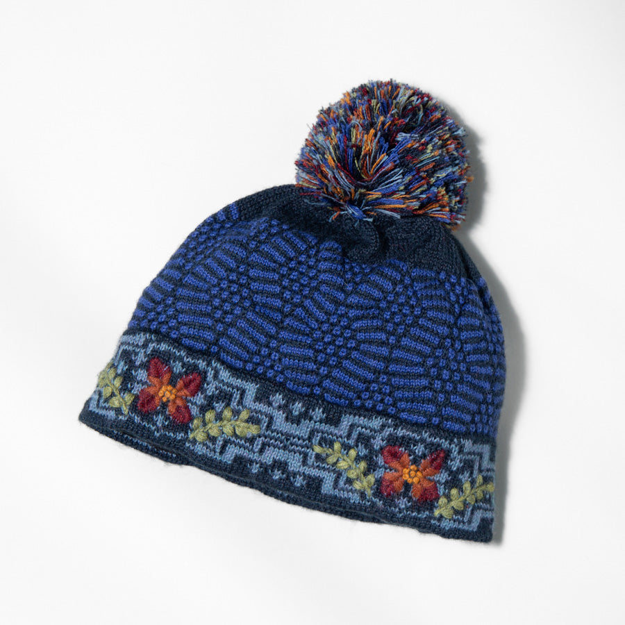 Blue alpaca embroidered beanie hat with colorful yarn pompom