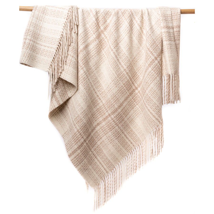 An Alpacas of Montana soft cozy luxury warm natural white with chestnut brown accent heather plaid blanket with a tasseled edge.