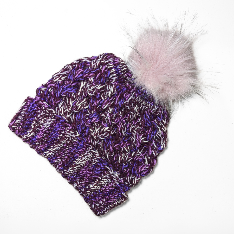 Deep purple, bright purple violet, and white colored cozy soft warm handmade knitted crochet celtic hat with a light pink pom pom made in Montana by Alpacas of Montana.