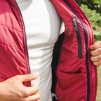 A close up photo of the inside of a cranberry red Alpacas of Montana lightweight athletic activewear outerwear breathable moisture wicking antimicrobial soft comfortable exercise alpaca men's stretch lite vest for running sports exercise work out hiking climbing camping biking