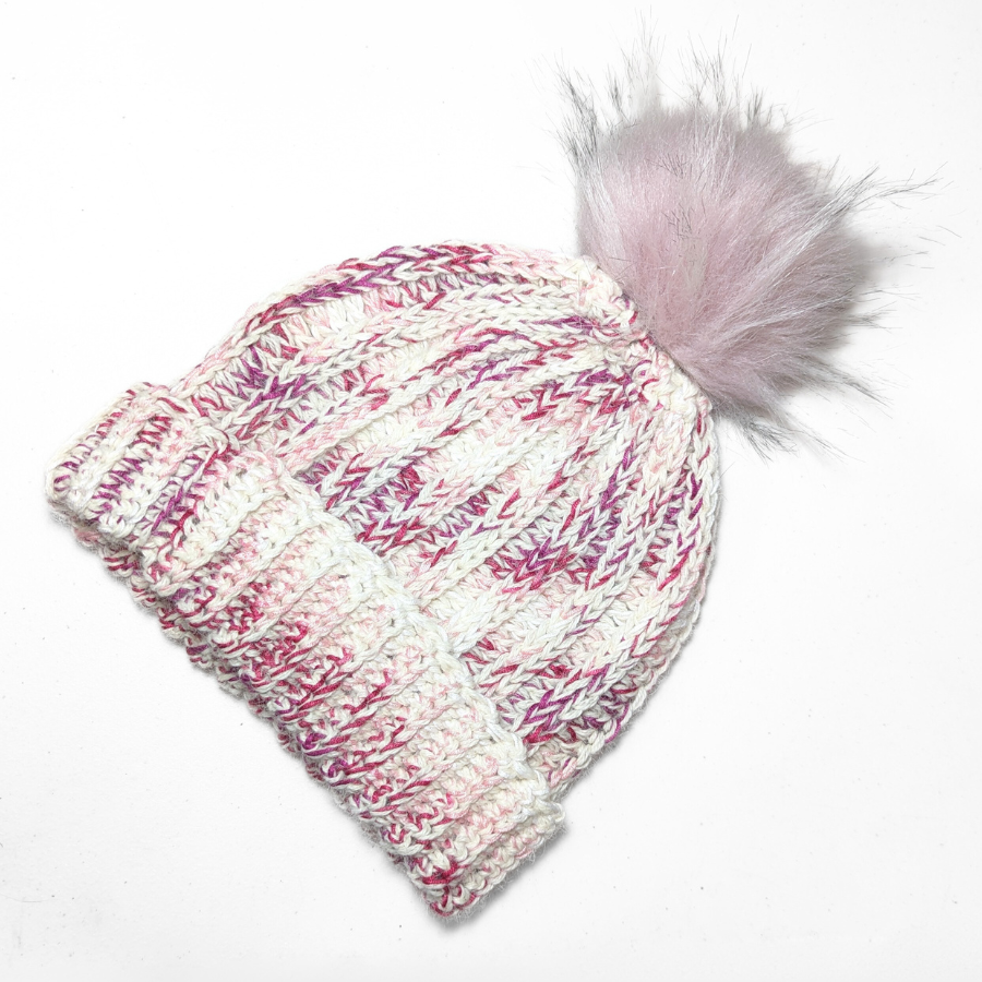 Fuchsia, dark pink, light pink, carnation, and white colored cozy soft warm handmade knitted crochet ridge ribbed hat with a light pink pom pom made in Montana by Alpacas of Montana.