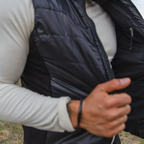 A close up photo of the black Alpacas of Montana lightweight athletic activewear outerwear breathable moisture wicking antimicrobial soft comfortable exercise alpaca men's stretch lite vest for running sports exercise work out hiking climbing camping biking