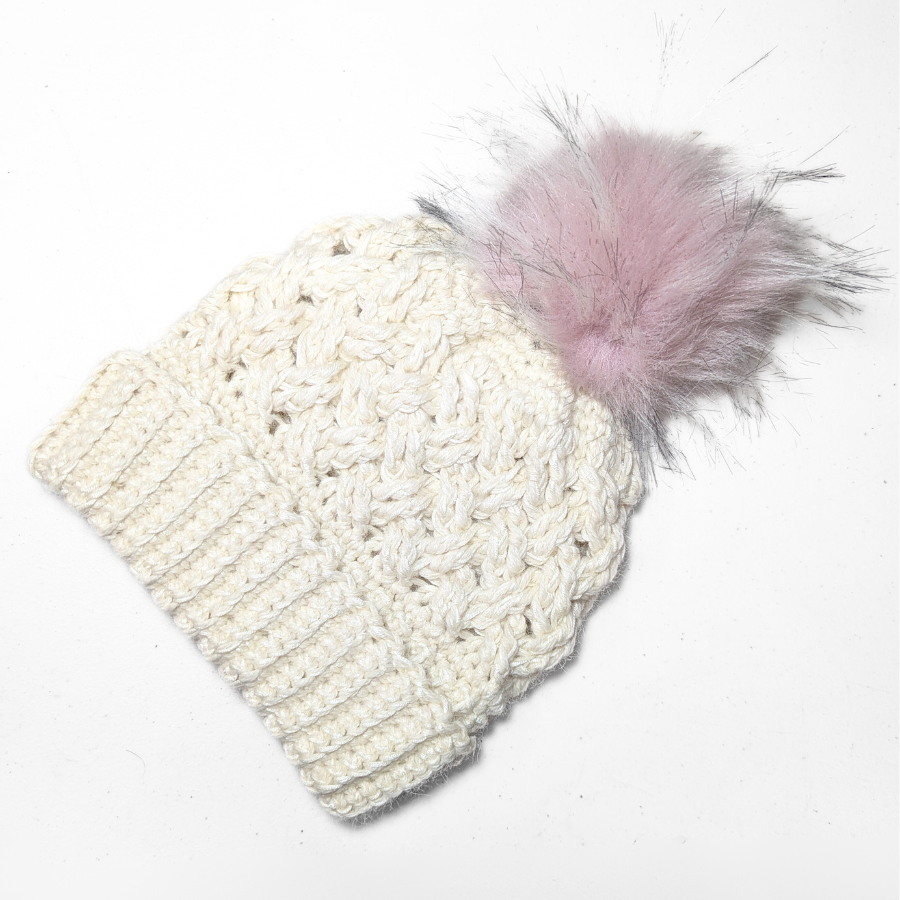 Natural white color cozy soft warm handmade knitted crochet celtic hat with a light pink pom pom made in Montana by Alpacas of Montana.