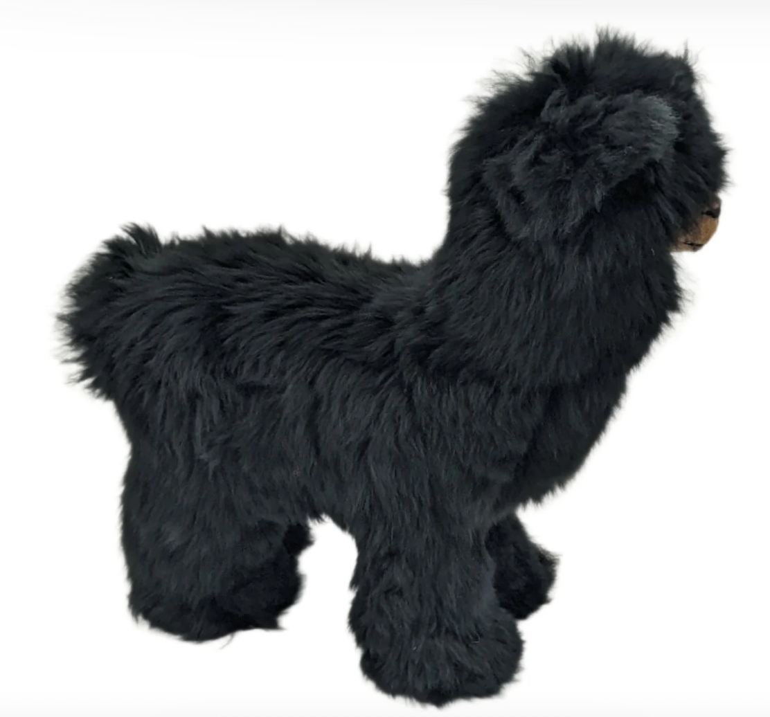 Black plush alpaca toy on a white background that is soft with thick fur