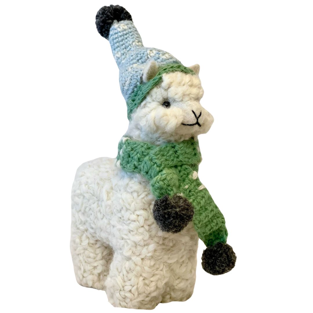 white alpaca ornament with a string wearing a blue hat and green scarf with pom poms