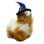 Plush toy llama wearing a Halloween blue wizard hat on a white background