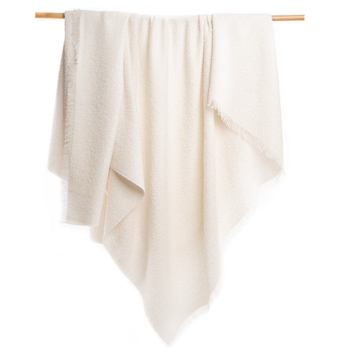 Beige towel hanging on a wooden rod against a white background