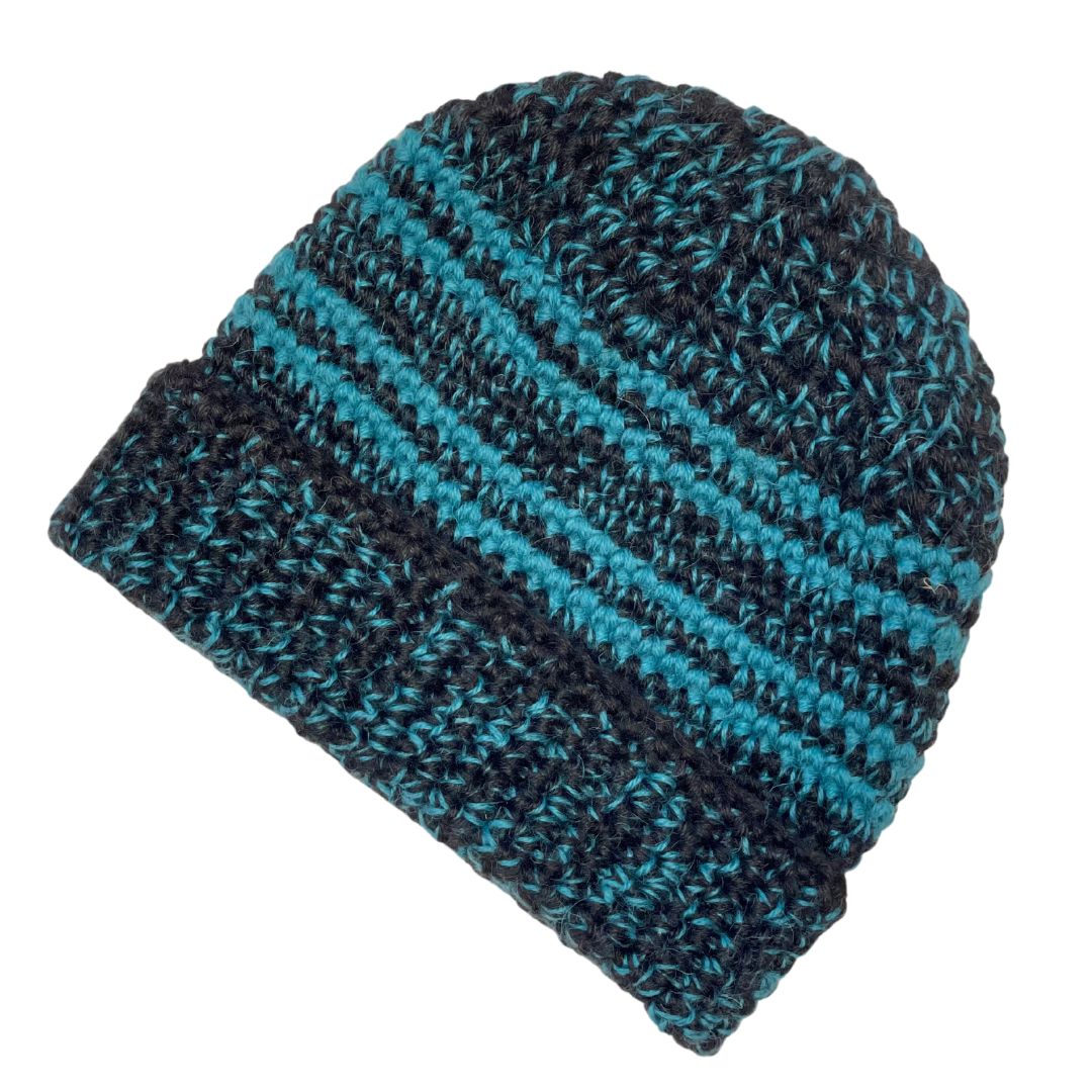 A product photo with a white background of an Alpacas of Montana soft cozy comfortable stylish thermal fashionable moisture wicking antimicrobial knitted crochet toboggan rolled cuff beanie hat handmade in Montana from black and bright teal aqua blue alpaca wool and bamboo yarn.