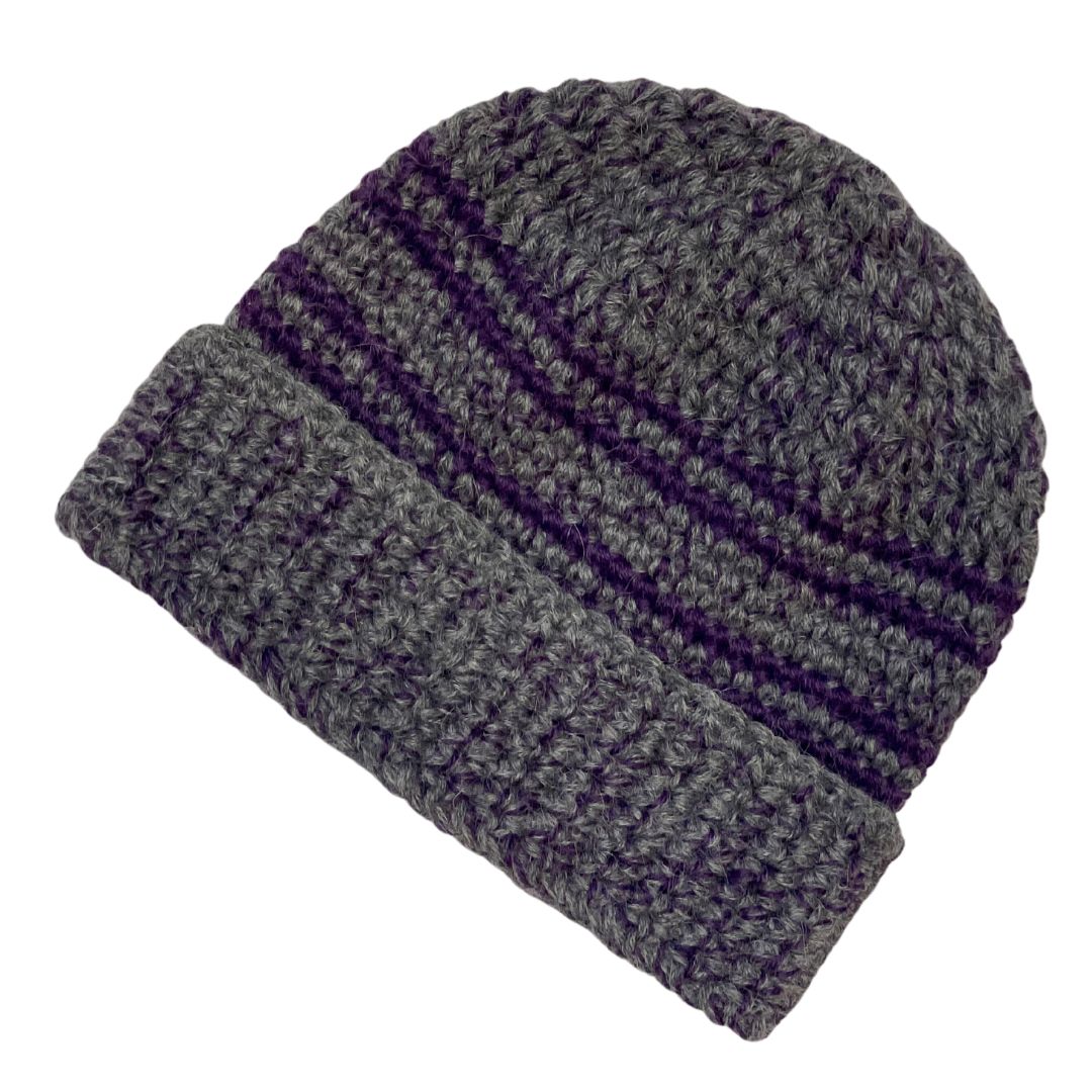 A product photo with a white background of an Alpacas of Montana soft cozy comfortable stylish thermal fashionable moisture wicking antimicrobial knitted crochet toboggan rolled cuff beanie hat handmade in Montana from dark gray and bright purple violet alpaca wool and bamboo yarn.