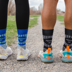 A close up photo of two people's feet wearing running shoes and Alpacas of Montana soft cozy comfortable activewear outerwear athletic workout moisture wicking antimicrobial cushioned light compression engineered high-tech mid-crew hiking sock for walking, skiing, climbing, hunting, camping, fishing, exercise, biking