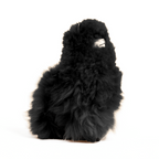 A black plush alpaca toy that is fluffy and soft