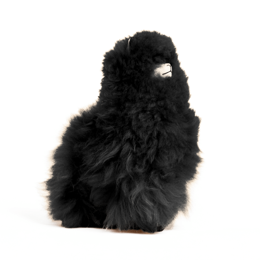 A black plush alpaca toy that is fluffy and soft
