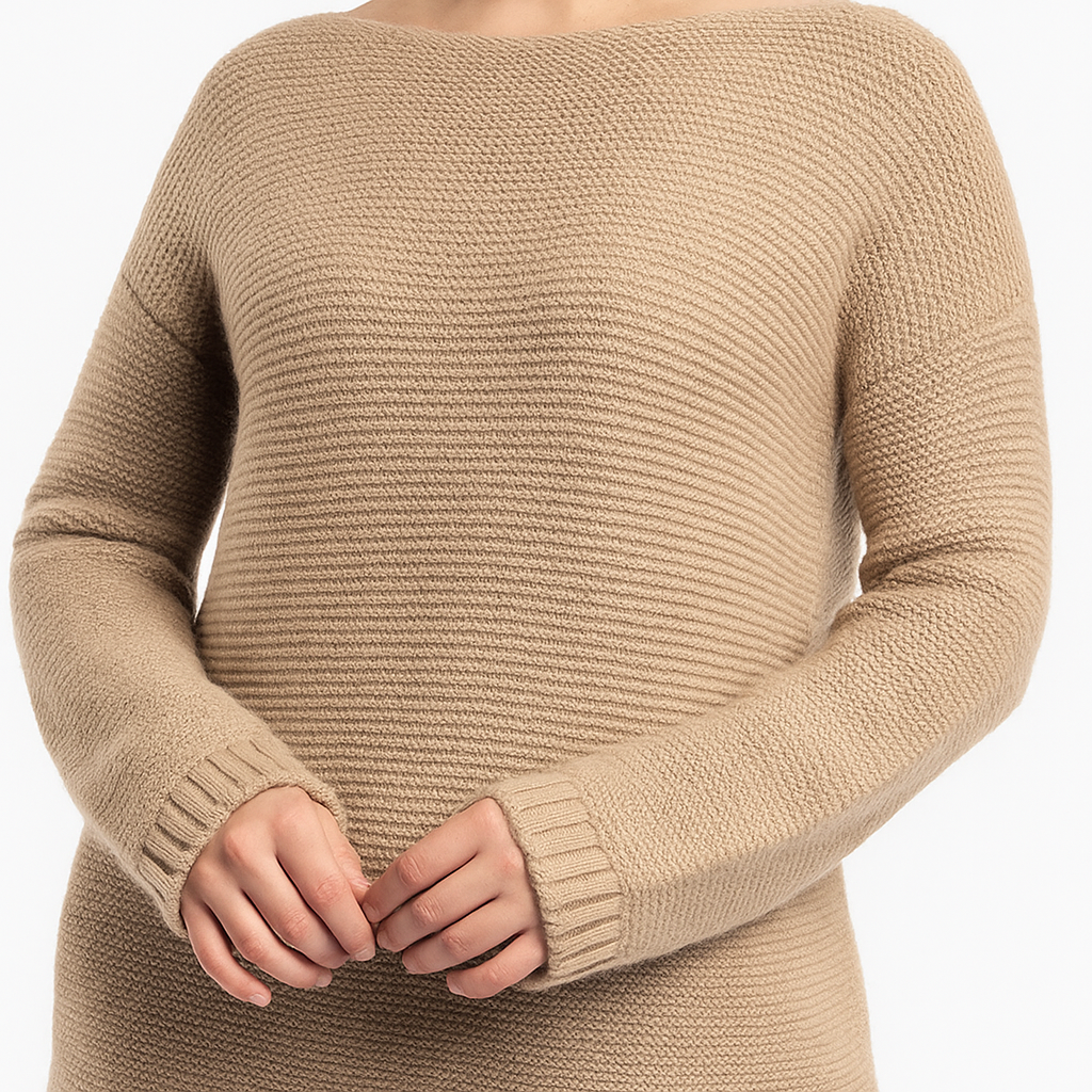 Close-up photo of a beige ribbed knit sweater with a boat neckline and long sleeves, showing the soft texture and detailed stitching while the model gently clasps her hands.
