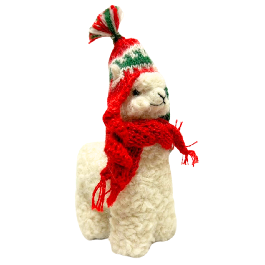 Plush llama toy wearing a red scarf and holiday hat on a white background