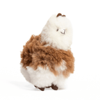 A brown and white plush toy resembling an alpaca with beige fleece, black eyes, and a brown nose.