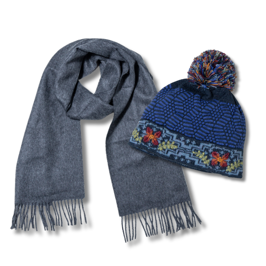 Gray scarf and blue knit hat with pom-pom on a white background