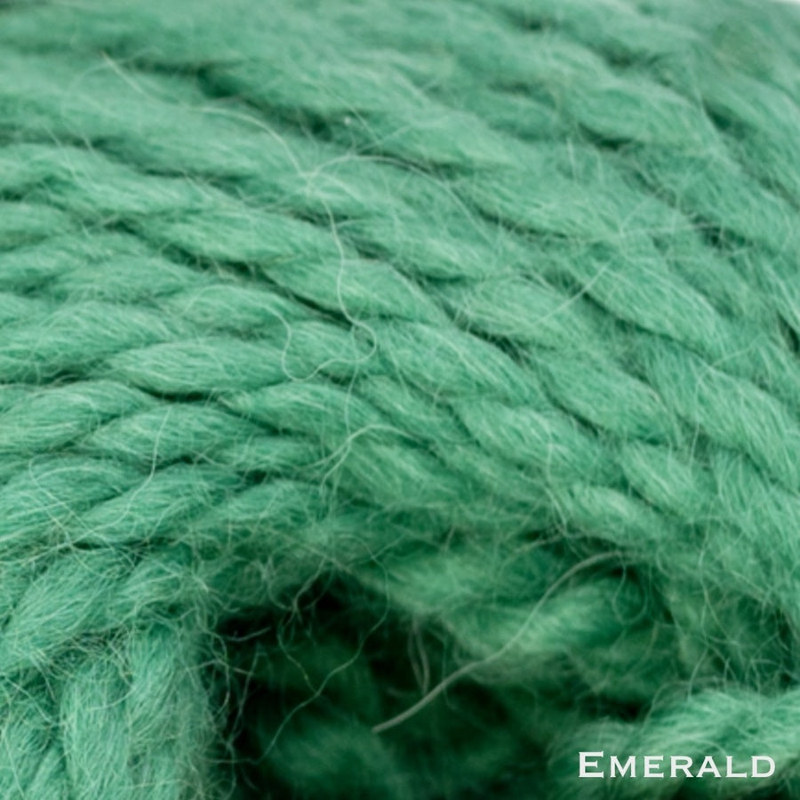 Close-up of emerald green wool yarn with 'Emerald' text.