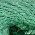 Close-up of emerald green wool yarn with 'Emerald' text.