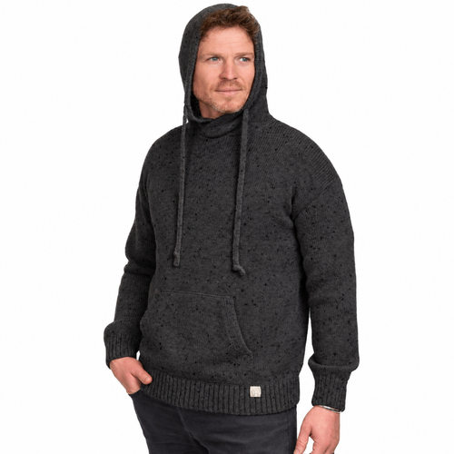 A man wearing a dark charcoal gray textured knit hooded sweater with a high collar and drawstrings, paired with dark pants, against a plain white background.