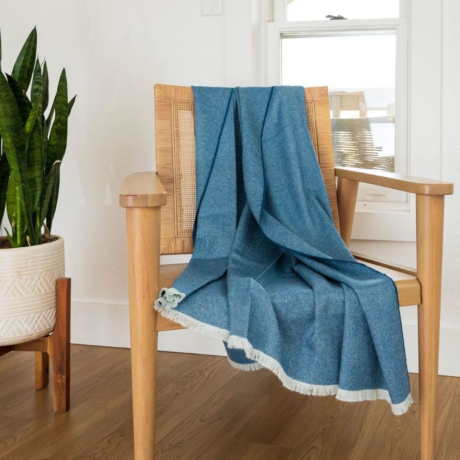 warm blue herringbone alpaca wool blanket on a wooden chair