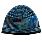 A product photo of the Alpacas of Montana soft cozy comfortable warm winter outerwear hiking skiing moisture wicking teal, blue, purple, gray, and black Multi-Blue Backcountry Beanie.
